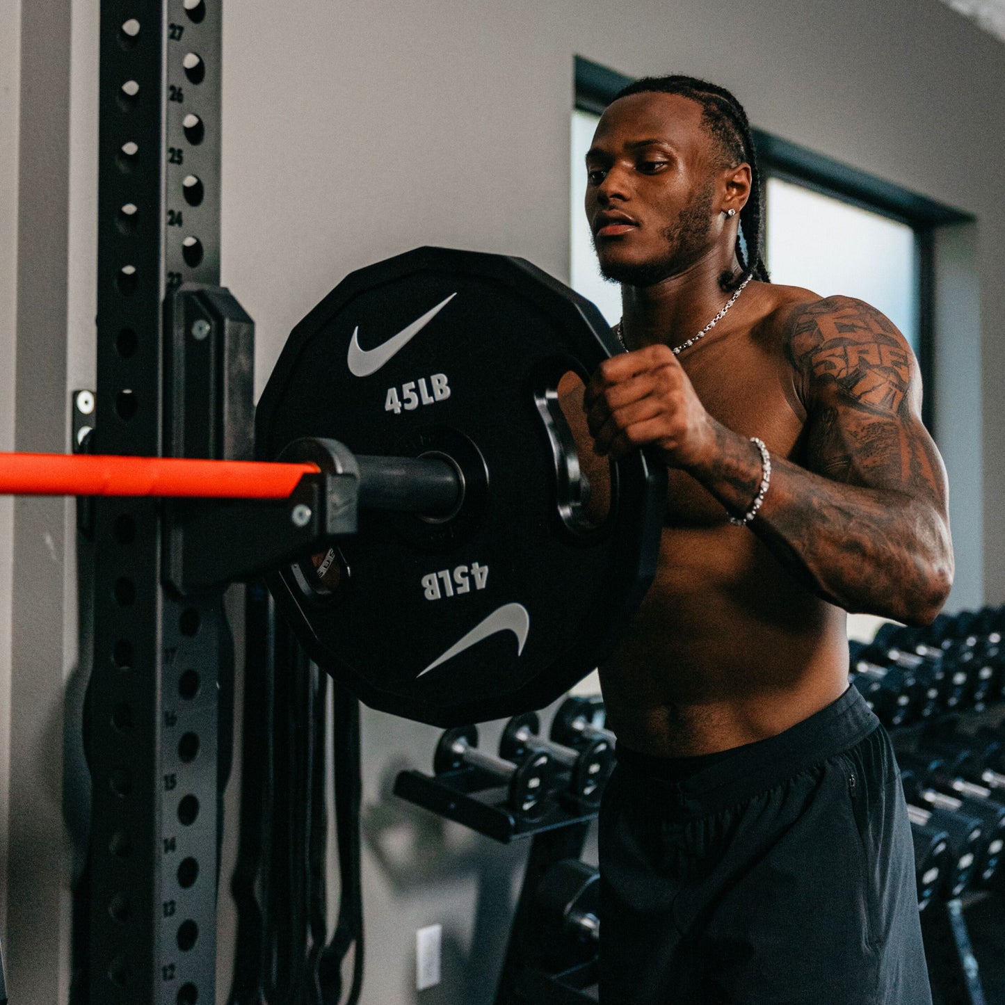 Nike Strength weight plates showing two different design options with detailed view of grip handles and weight markings.