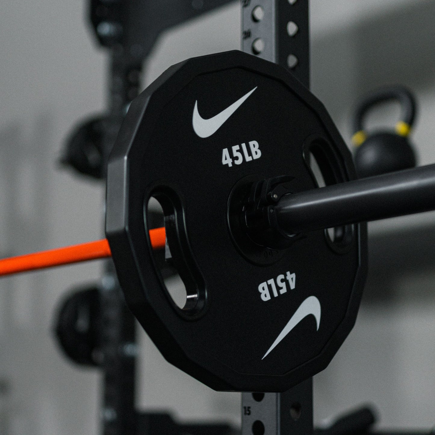 Weight plate comparison showing three different Nike Strength plate designs with varying features and finishes.