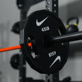 Weight plate comparison showing three different Nike Strength plate designs with varying features and finishes.
