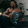 Comparison of four Nike Strength weight plate designs showing different sizes, features, and functional elements.